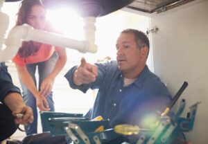 Plumbers,Working,On,Pipes,Under,Sink